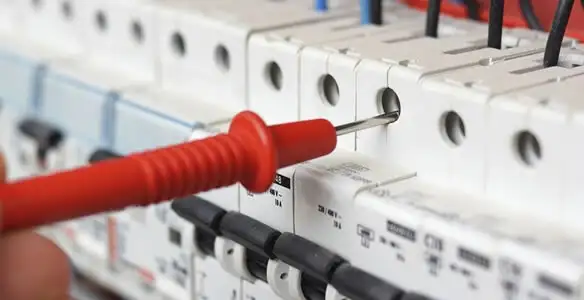 Electrical contractor testing circuit breakers during electrical repair in Somerville, MA