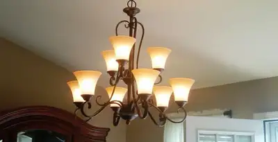 Classic ceiling chandelier installation with warm lighting in Cambridge, MA