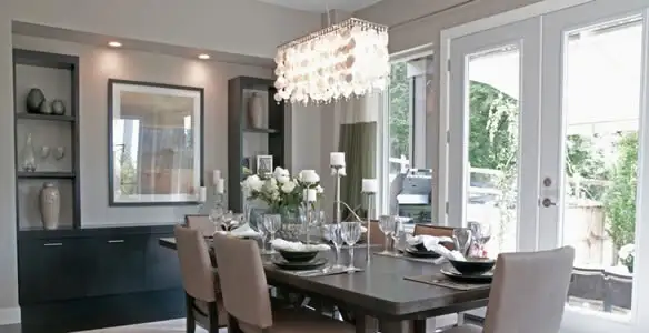 Elegant dining room chandelier installation above table in Cambridge, MA