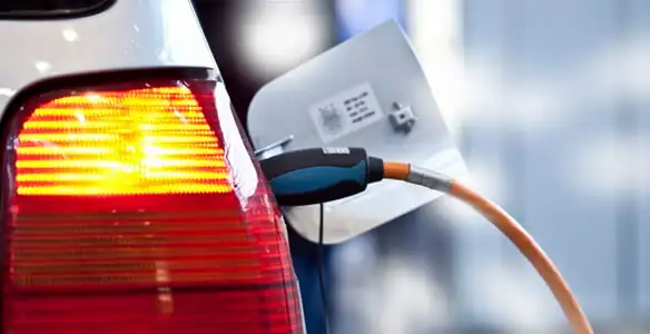 Electric car plugged into EV charger after professional installation in Cambridge, MA