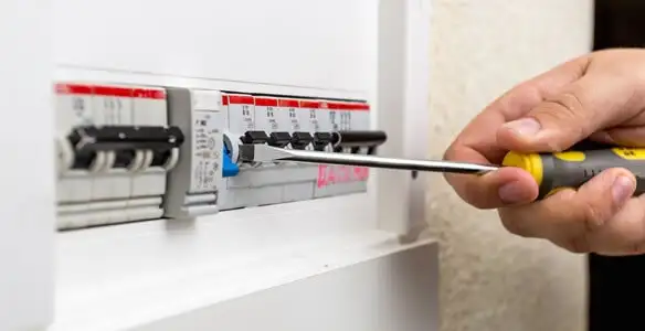 electrical panel upgrade service showing technician adjusting circuit breakers during system upgrade in Cambridge, MA