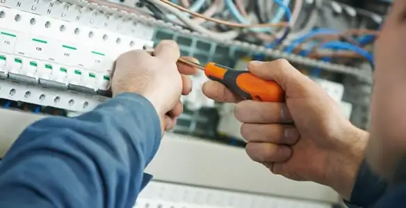 electrical service showing licensed electrician performing electrical panel maintenance and adjustments in Cambridge, MA