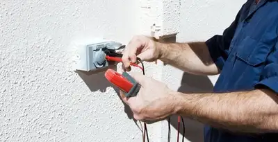 Electrician performing home electrical outlet and wiring inspection in Cambridge, MA