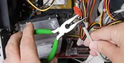 Licensed electrical contractor performing electrical repair with tools in Charlestown, MA