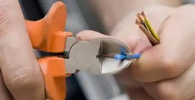 professional electrical services showing precise wire cutting by licensed electricians in Cambridge, MA