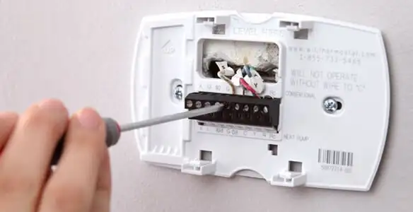 Thermostat installation service with proper wiring and secure wall mounting in Cambridge, MA