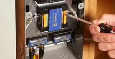 Whole home surge protection device being installed by a licensed electrician to protect electrical systems in Cambridge, MA